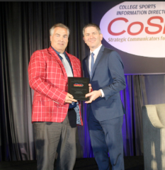 Chris Wenzler receiving the 2018 CoSIDA Bob Kenworthy Community Service Award from then President Rob Carolla.